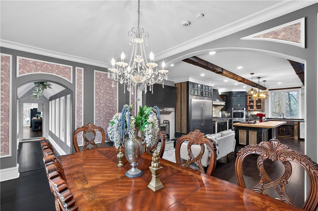 745 Goshen Road Thomaston, GA 30286 - Photo 13 of 41 a dining room with furniture a chandelier and wooden floor