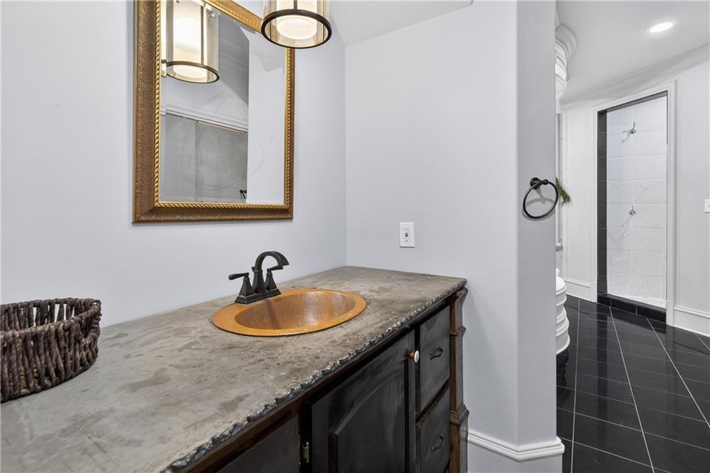 745 Goshen Road Thomaston, GA 30286 - Photo 17 of 41 a bathroom with a sink a vanity and a mirror