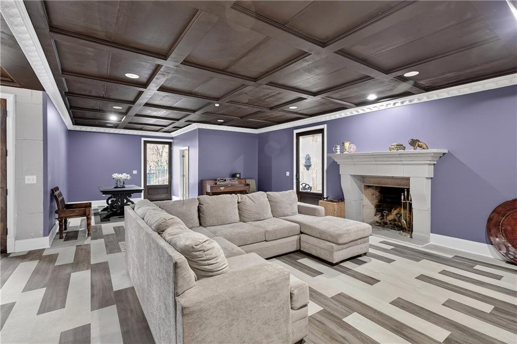 745 Goshen Road Thomaston, GA 30286 - Photo 32 of 41 a living room with couches chairs and a fireplace with wooden floor