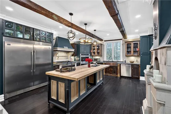 a kitchen with stainless steel appliances granite countertop a stove and a refrigerator