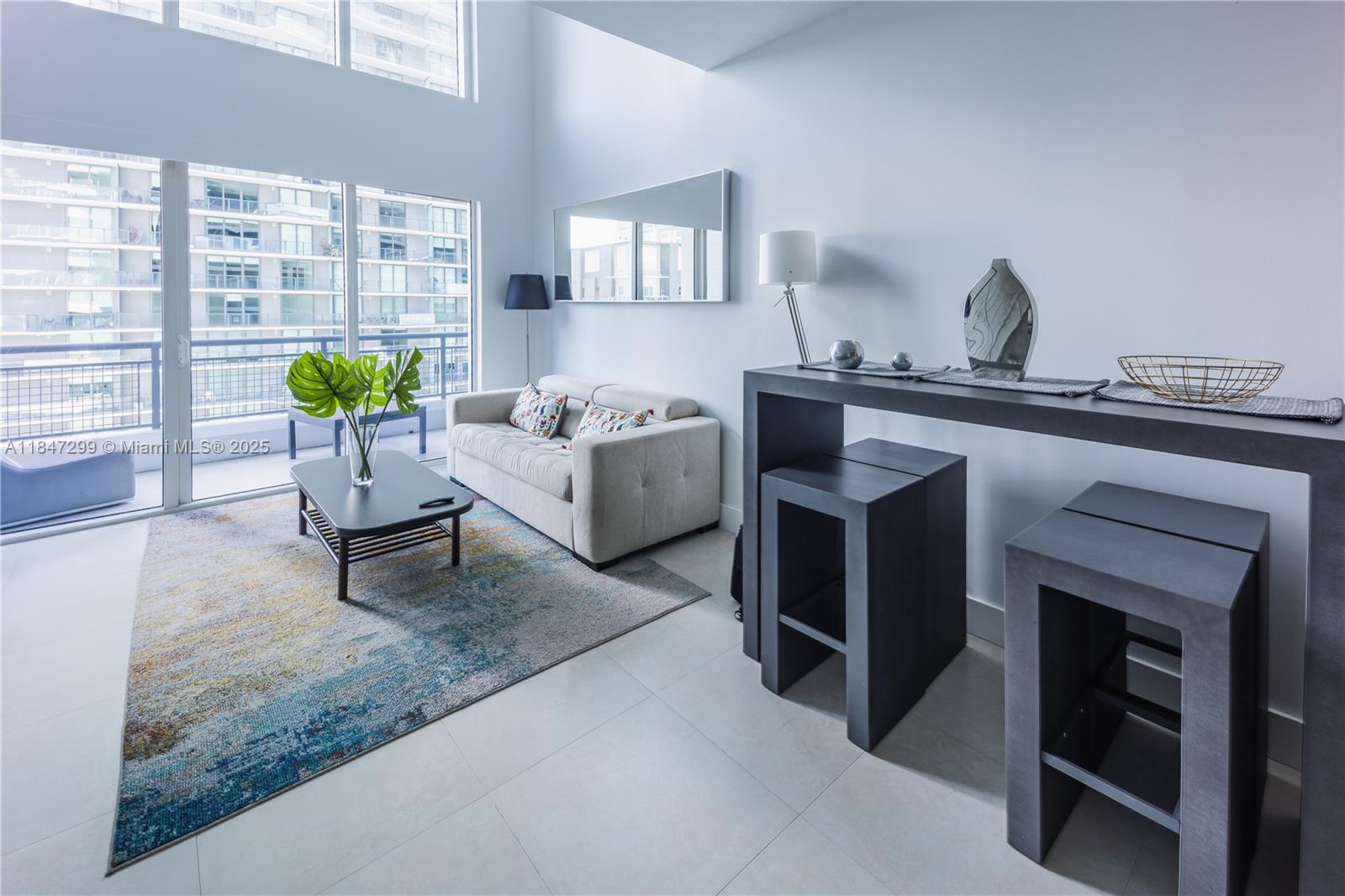 60 Southwest 13th Street, Unit 3222 Miami, FL 33130 - Photo 2 of 23 a living room with furniture and a fireplace