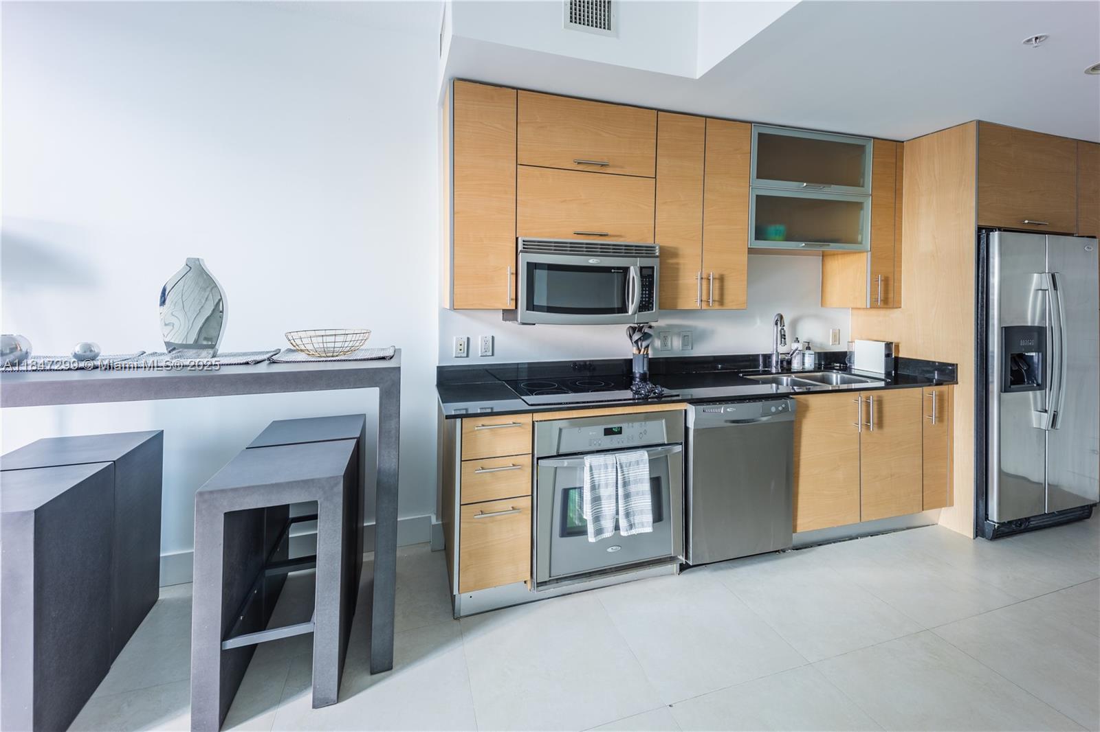60 Southwest 13th Street, Unit 3222 Miami, FL 33130 - Photo 9 of 23 a kitchen with granite countertop a sink stainless steel appliances and cabinets
