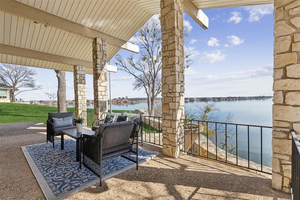 648 South Rough Creek Court Granbury, TX 76048 - Photo 6 of 26 a roof deck with couches and city view