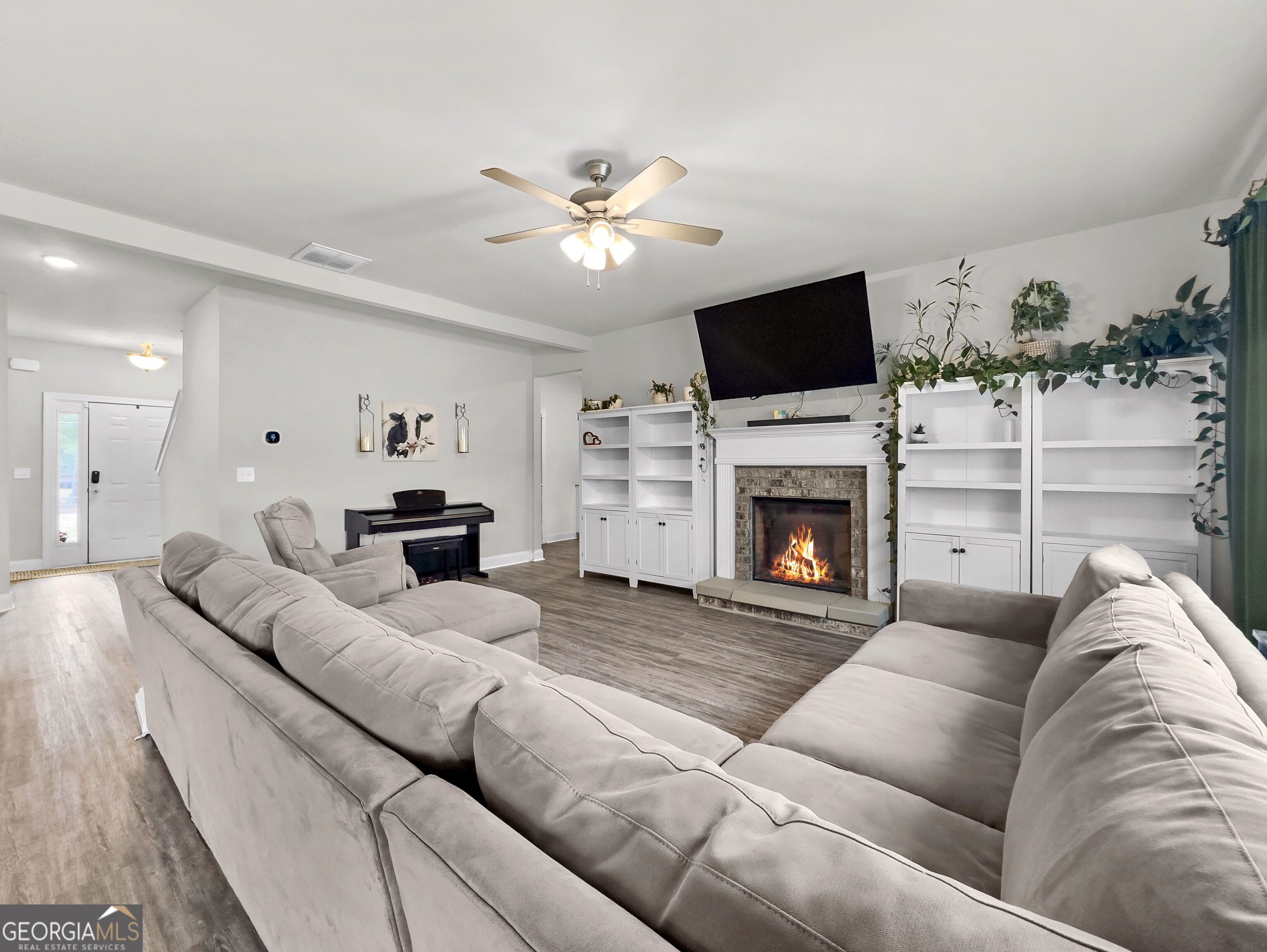 35 Sandy Ridge Road McDonough, GA 30252 - Photo 29 of 63 a living room with furniture a flat screen tv and a fireplace