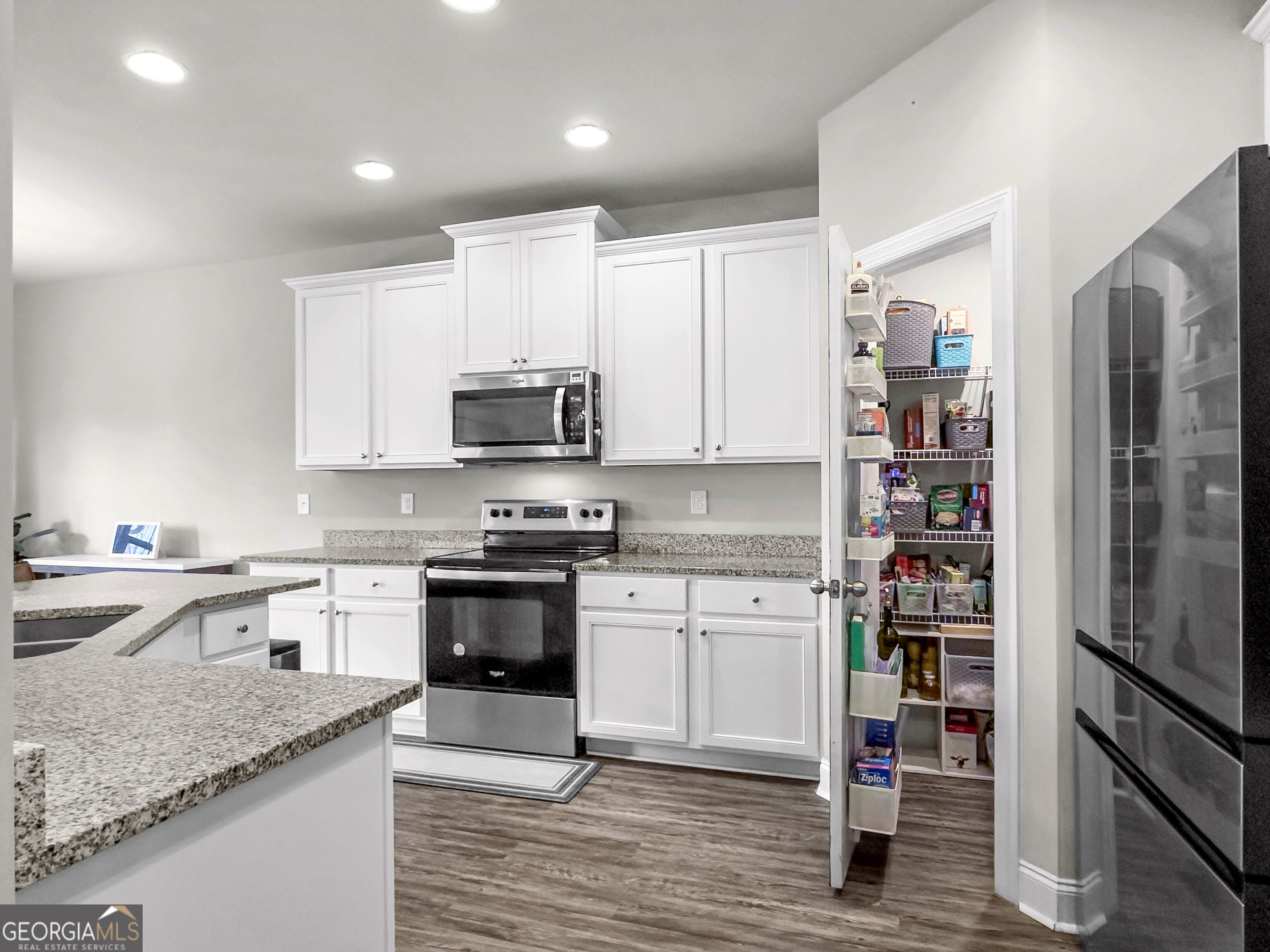 35 Sandy Ridge Road McDonough, GA 30252 - Photo 31 of 63 a kitchen with stainless steel appliances granite countertop a refrigerator and stove