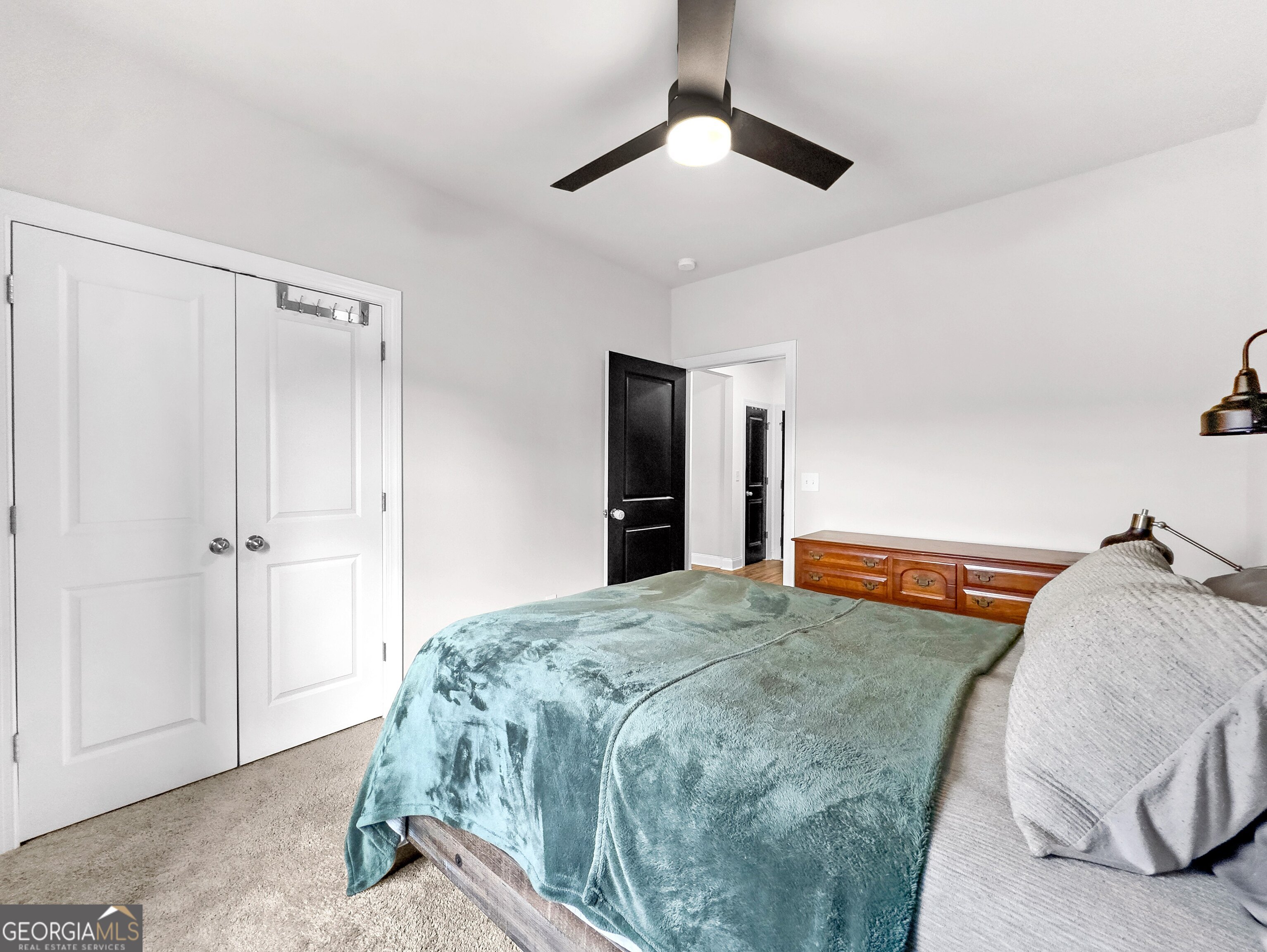 35 Sandy Ridge Road McDonough, GA 30252 - Photo 39 of 63 a bedroom with a large bed and a chandelier fan