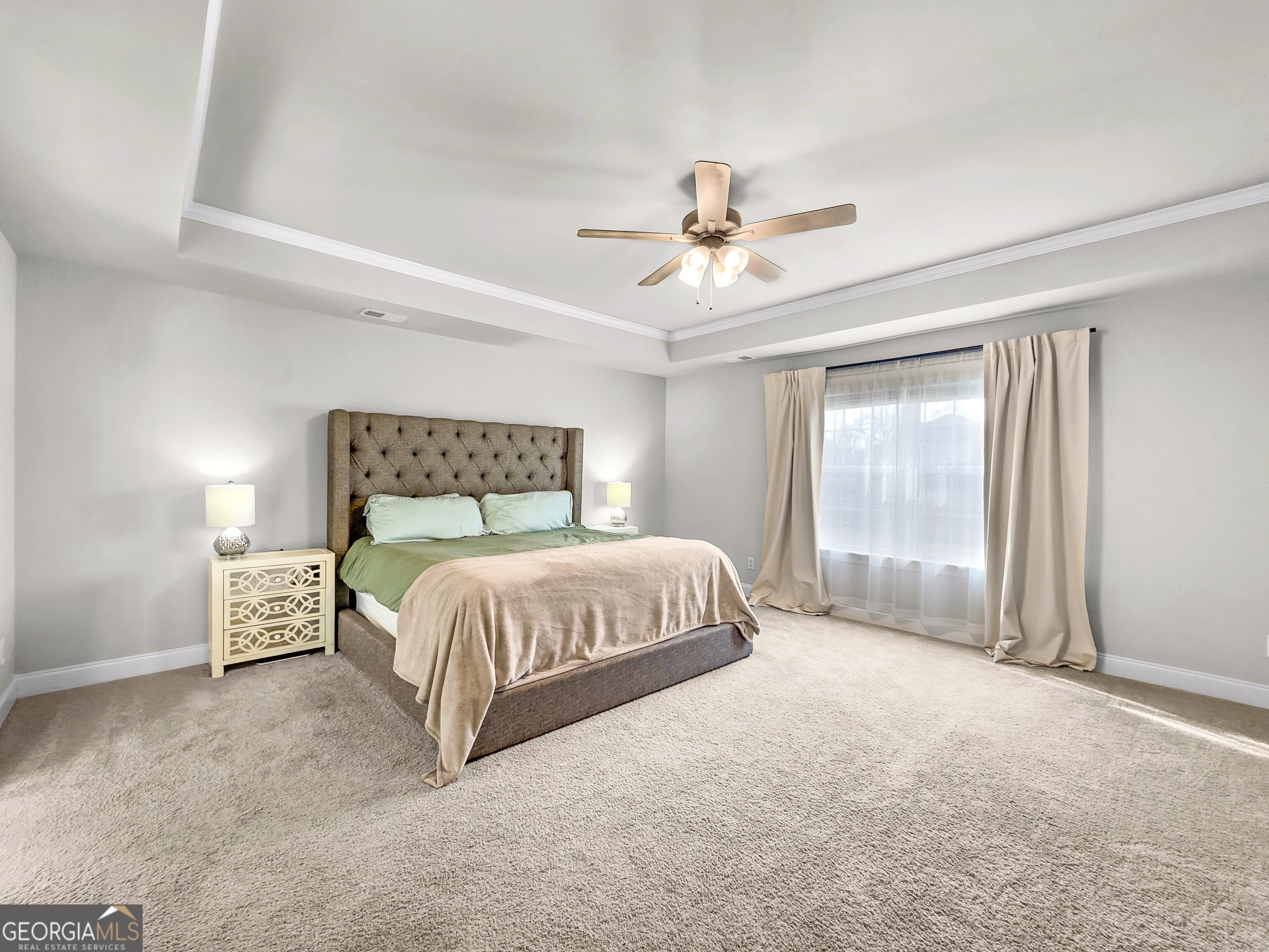 35 Sandy Ridge Road McDonough, GA 30252 - Photo 43 of 63 a spacious bedroom with a bed and a chandelier