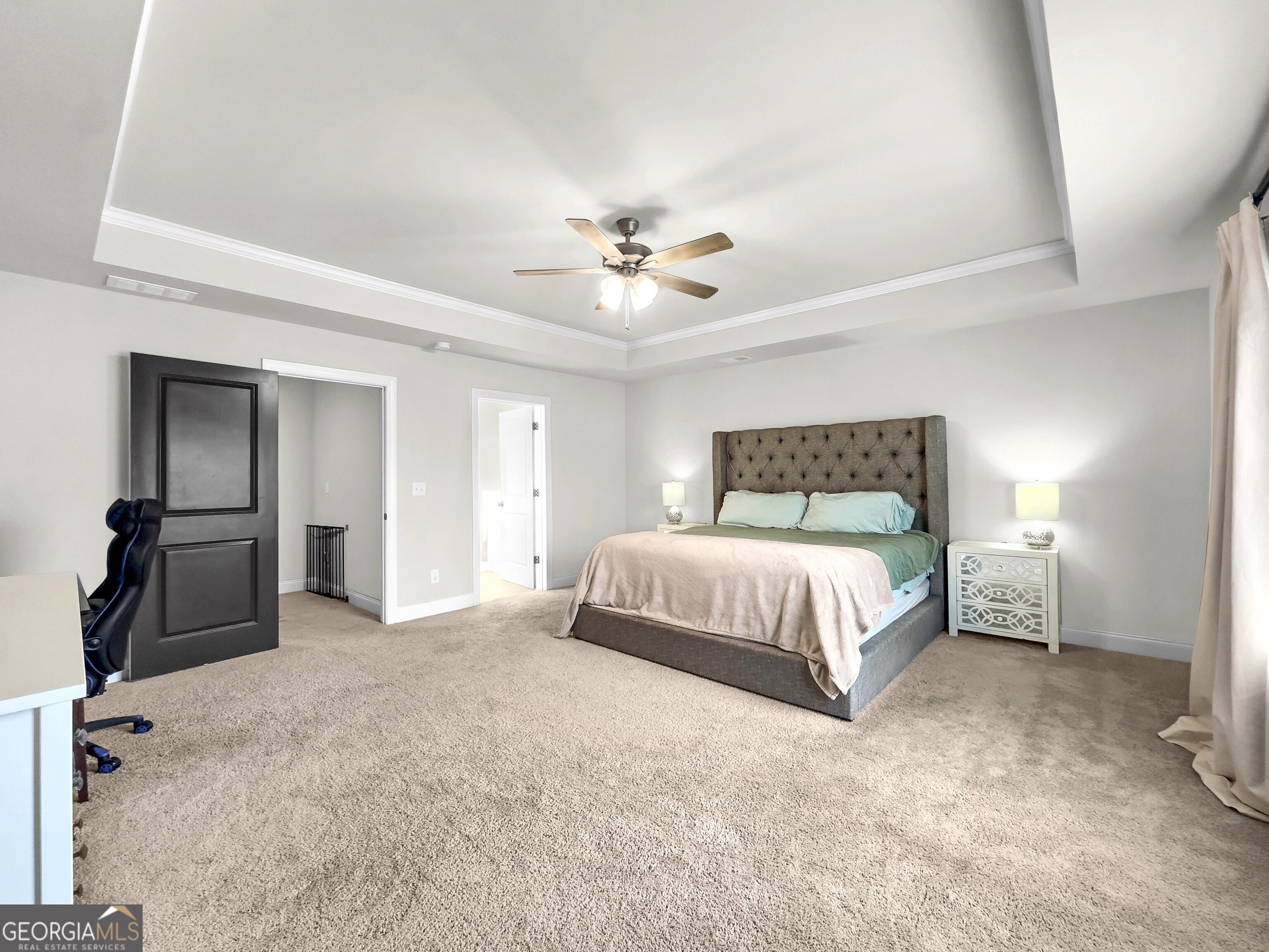 35 Sandy Ridge Road McDonough, GA 30252 - Photo 44 of 63 a bedroom with a bed and a chandelier