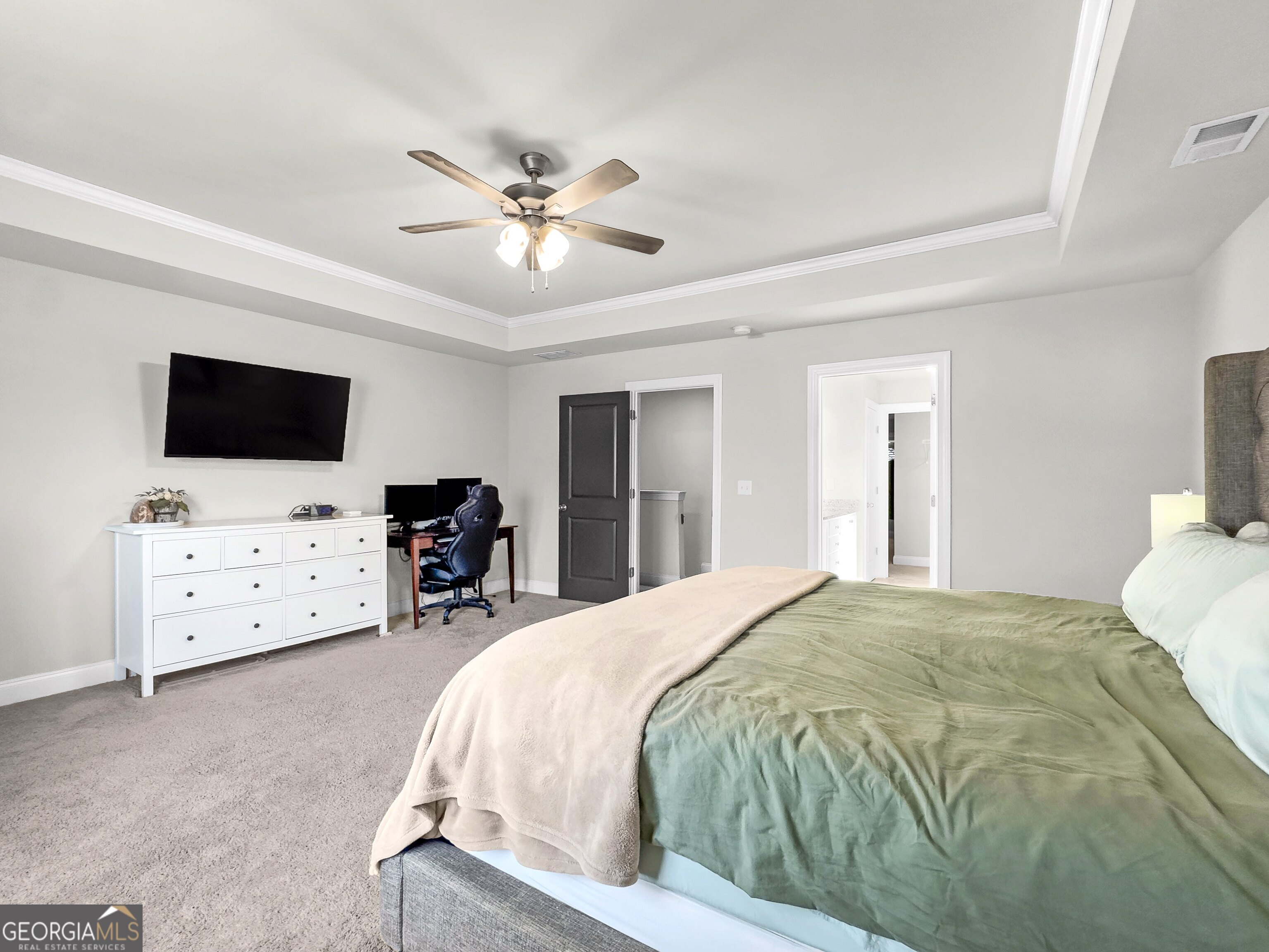 35 Sandy Ridge Road McDonough, GA 30252 - Photo 45 of 63 a spacious bedroom with a bed and flat screen tv