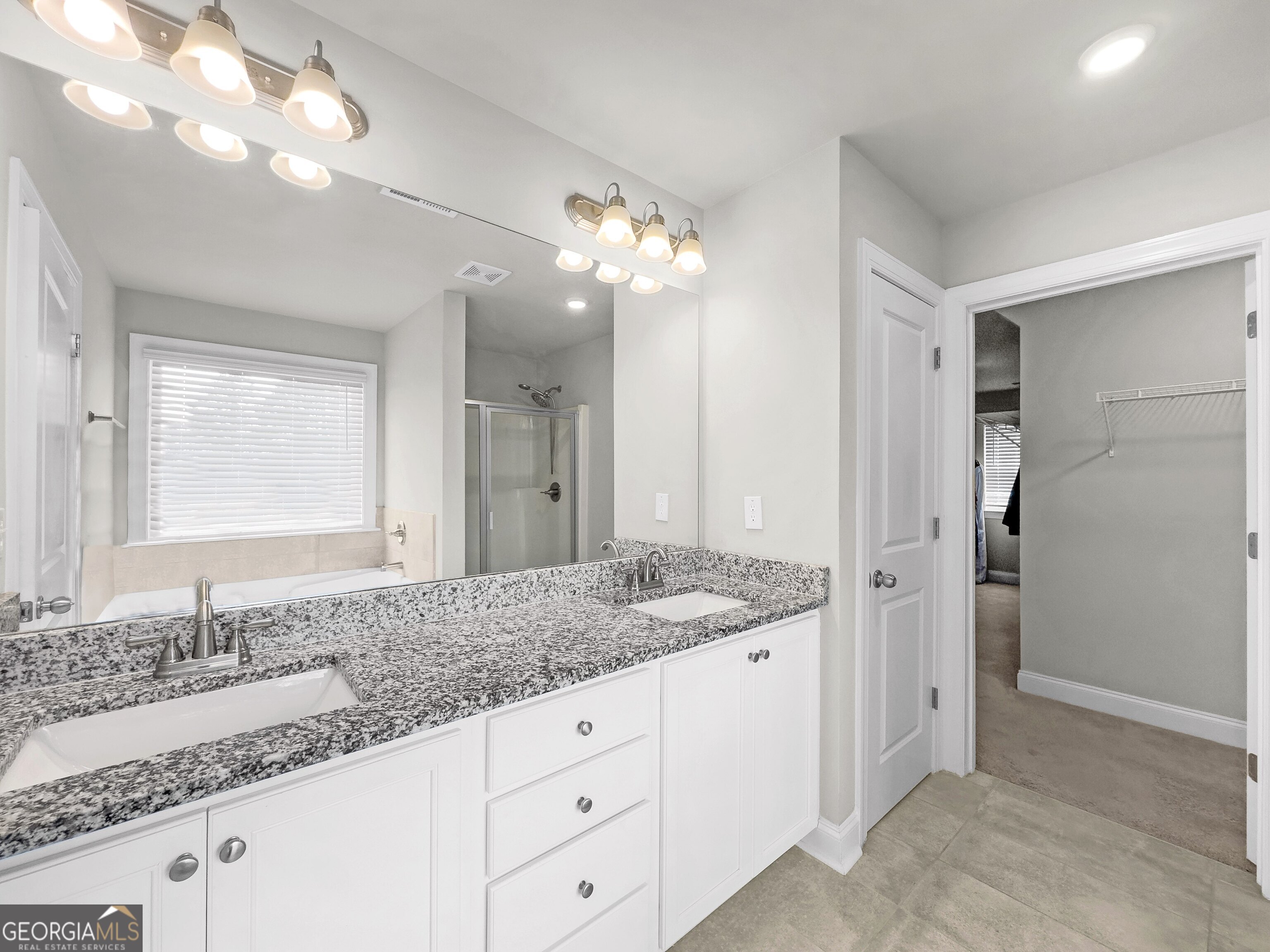 35 Sandy Ridge Road McDonough, GA 30252 - Photo 46 of 63 a bathroom with a granite countertop double vanity sink and a mirror