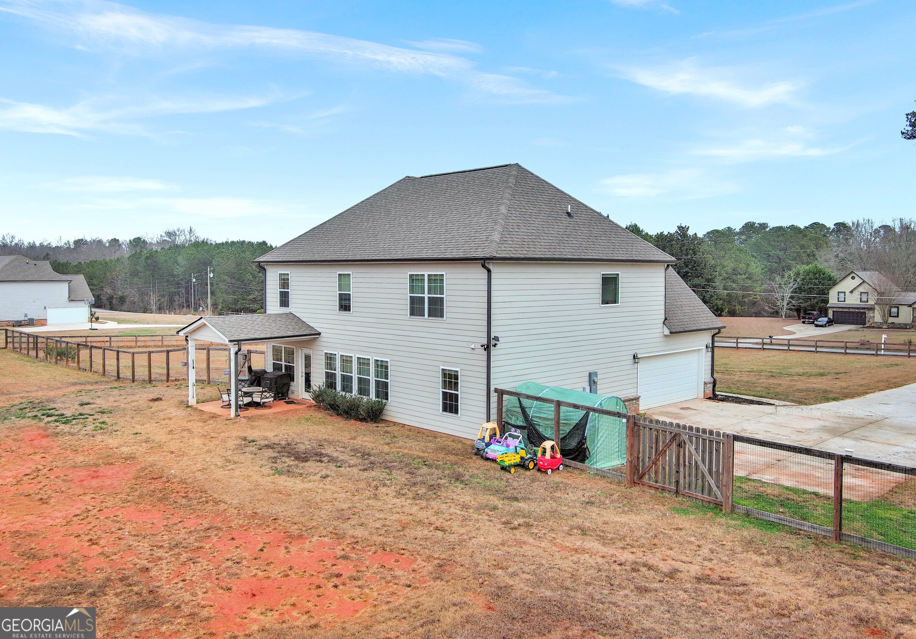 35 Sandy Ridge Road McDonough, GA 30252 - Photo 10 of 63 a view of a house with wooden deck and a floor to ceiling window