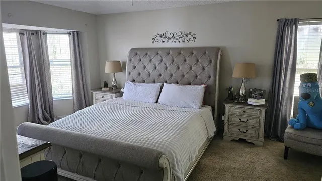 a bedroom with a large bed and a window