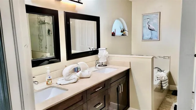 a bathroom with a sink vanity and mirror