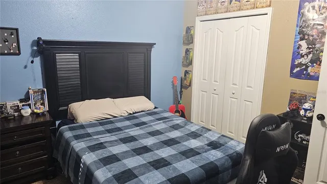 a bedroom with a bed and a dresser