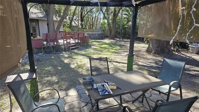 a dining room with furniture and a floor to ceiling window