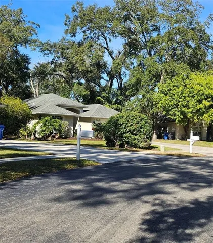 a view of swimming pool with outdoor seating and trees