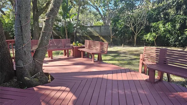 a view of a deck with chairs and wooden floor