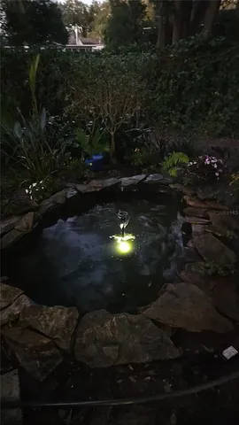 a sign that is on a wooden wall in the garden