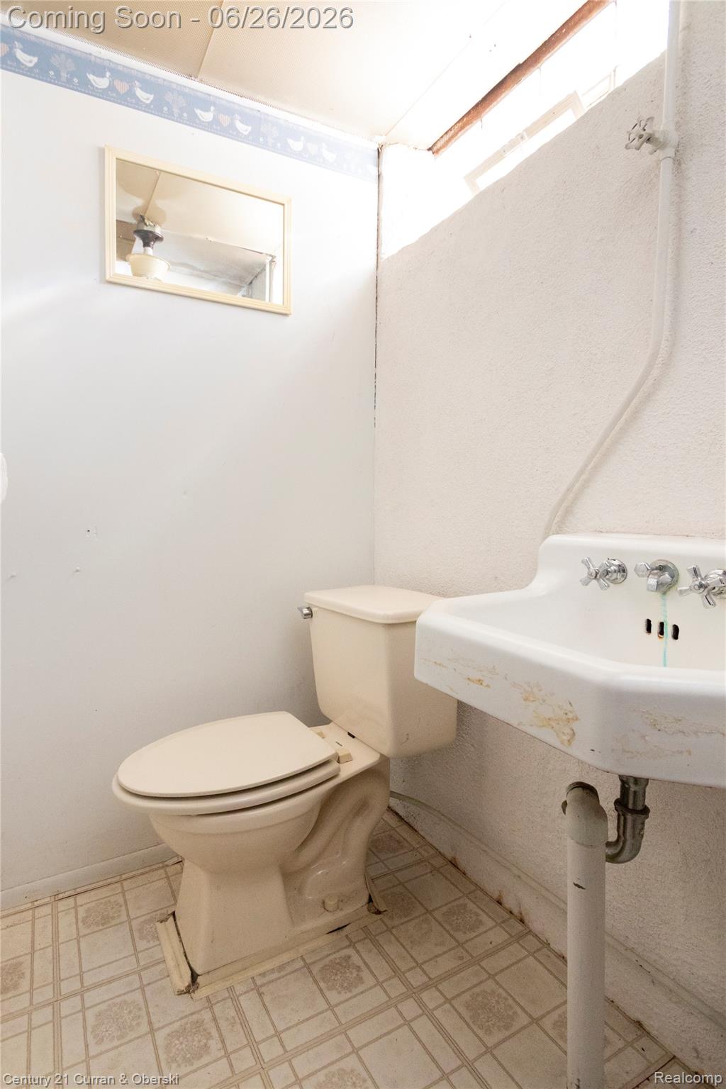 3220 Alice Street Dearborn, MI 48124 - Photo 30 of 39 Bathroom featuring a pedestal sink with chrome fixtures, a toilet, and patterned vinyl flooring