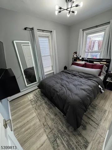a bedroom with a bed and a mirror