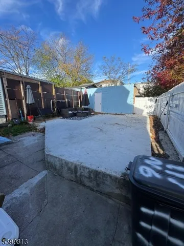 a view of a house with wooden fence