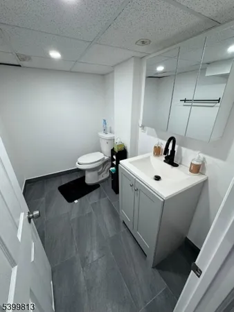 a white sink sitting next to a white cabinet