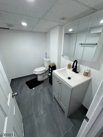 a white sink sitting next to a white cabinet