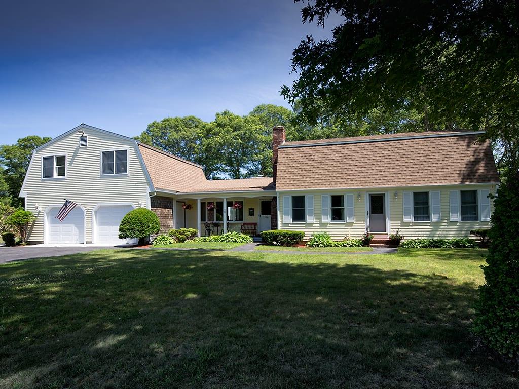 281 South Sandwich Road Mashpee, MA 02649 - Photo 1 of 25 a front view of a house with a garden