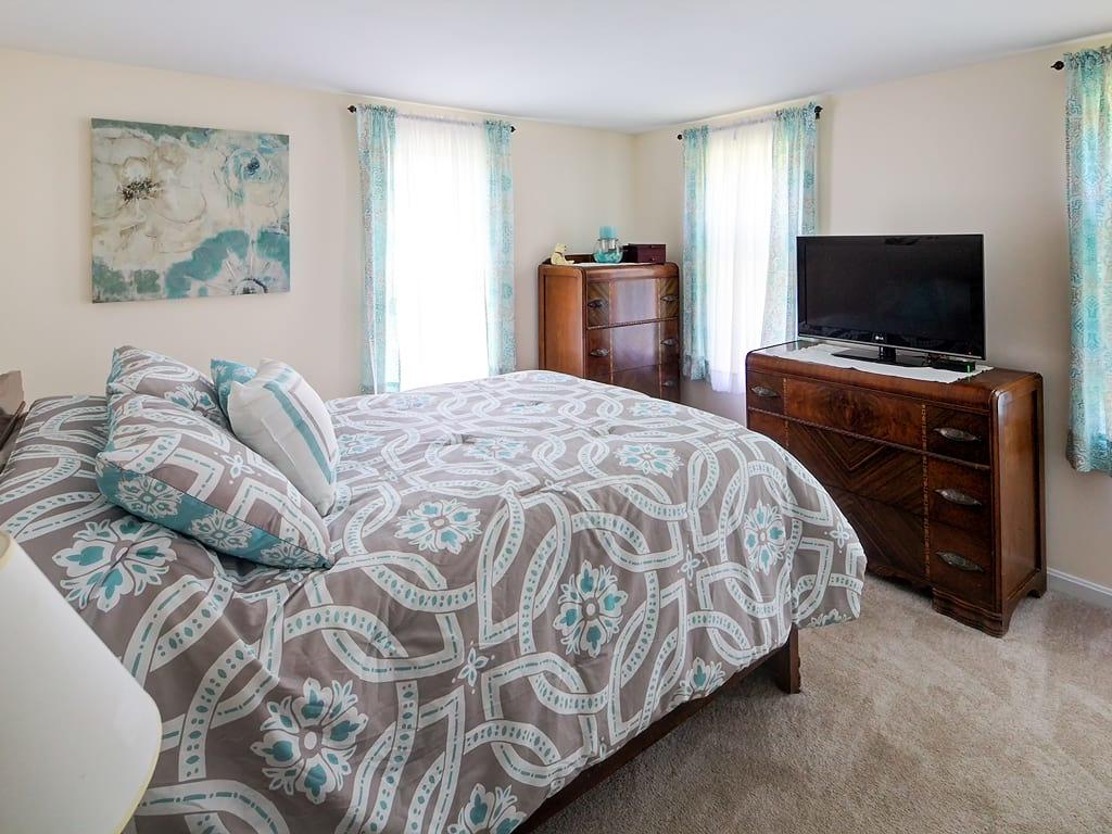 281 South Sandwich Road Mashpee, MA 02649 - Photo 12 of 25 a bedroom with a bed and a flat screen tv