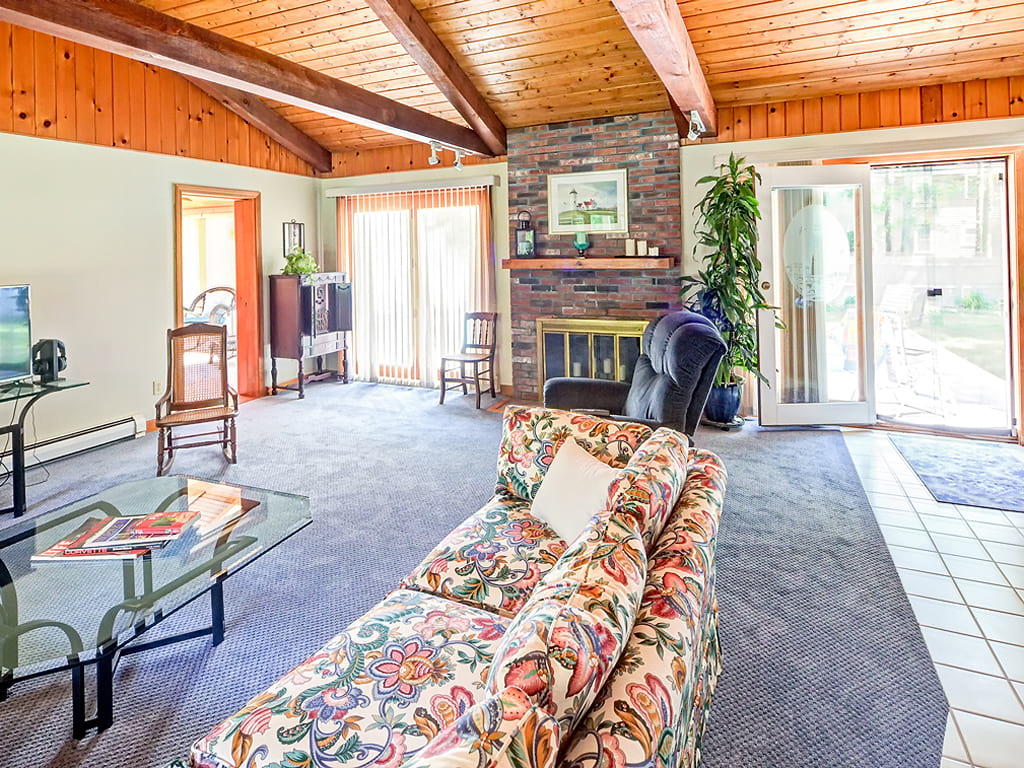 281 South Sandwich Road Mashpee, MA 02649 - Photo 5 of 25 a living room with furniture a fireplace and large windows