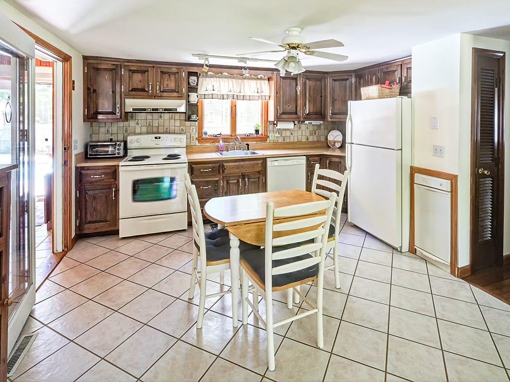 281 South Sandwich Road Mashpee, MA 02649 - Photo 8 of 25 a kitchen with stainless steel appliances a stove a refrigerator and a dining table view