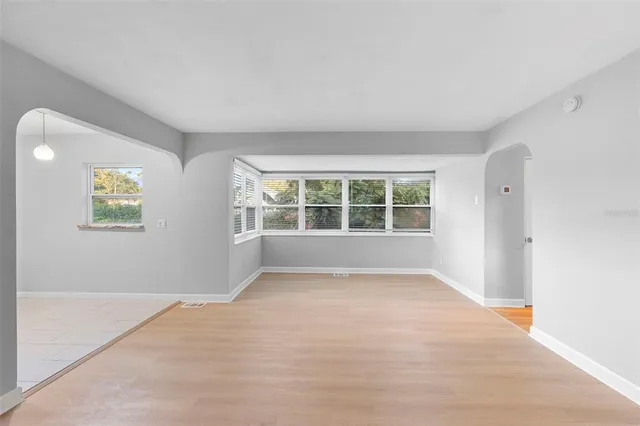 a view of a hallway with cabinets and wooden floor