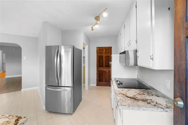 a bathroom with a toilet a sink a vanity and mirror