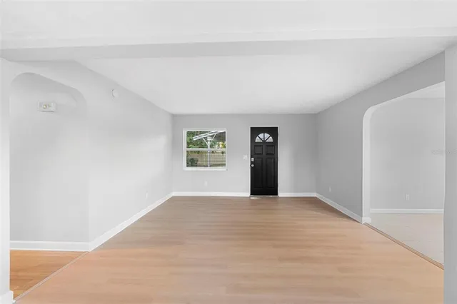 a kitchen with granite countertop a sink a stove and cabinets