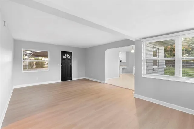 a kitchen with granite countertop white cabinets and stainless steel appliances