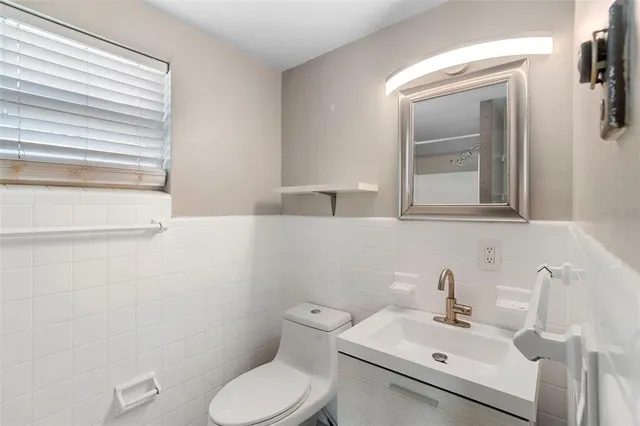 an empty room with a window and a ceiling fan