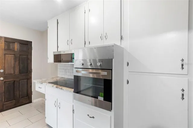 an empty room with a window and ceiling fan