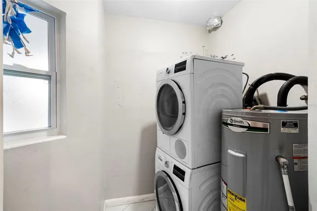 an empty room with a ceiling fan and window