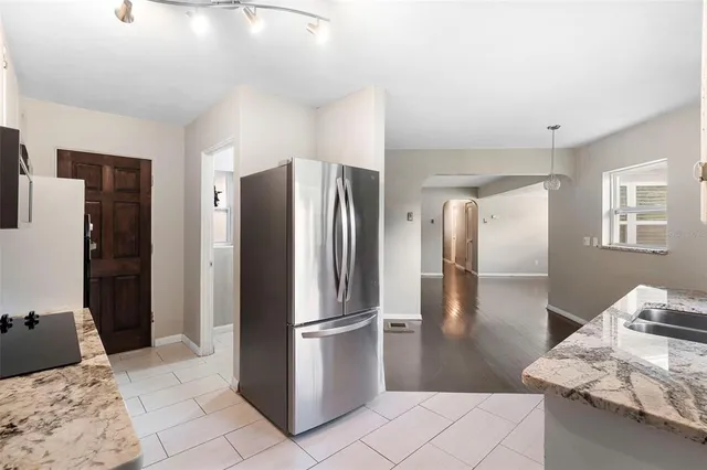 an empty room with a window and a ceiling fan