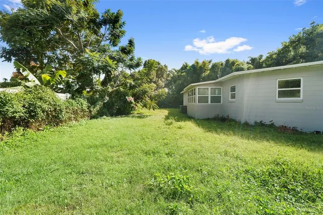 an aerial view of a house with a yard basket ball court and outdoor seating