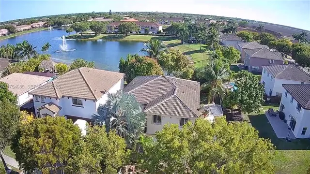 an aerial view of house with yard and lake view