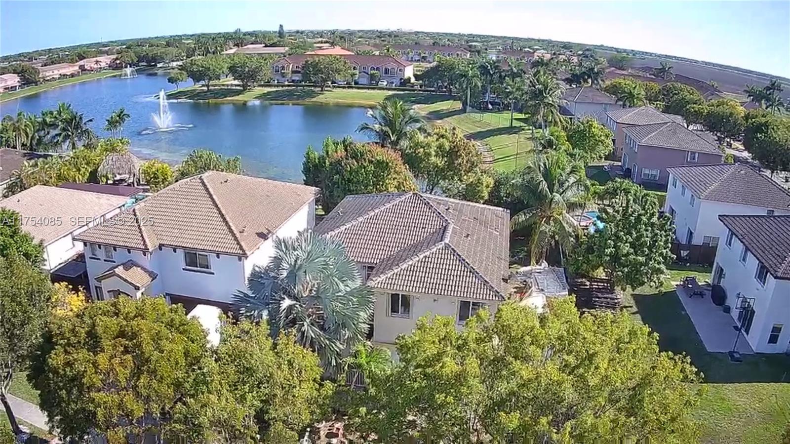 an aerial view of house with yard and lake view