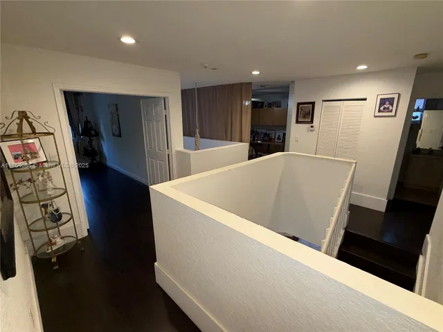a view of kitchen with stainless steel appliances wooden floor