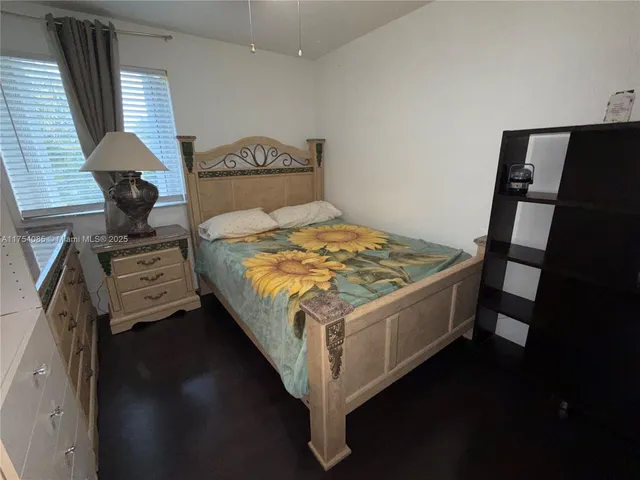 a bed sitting in a bedroom next to a window