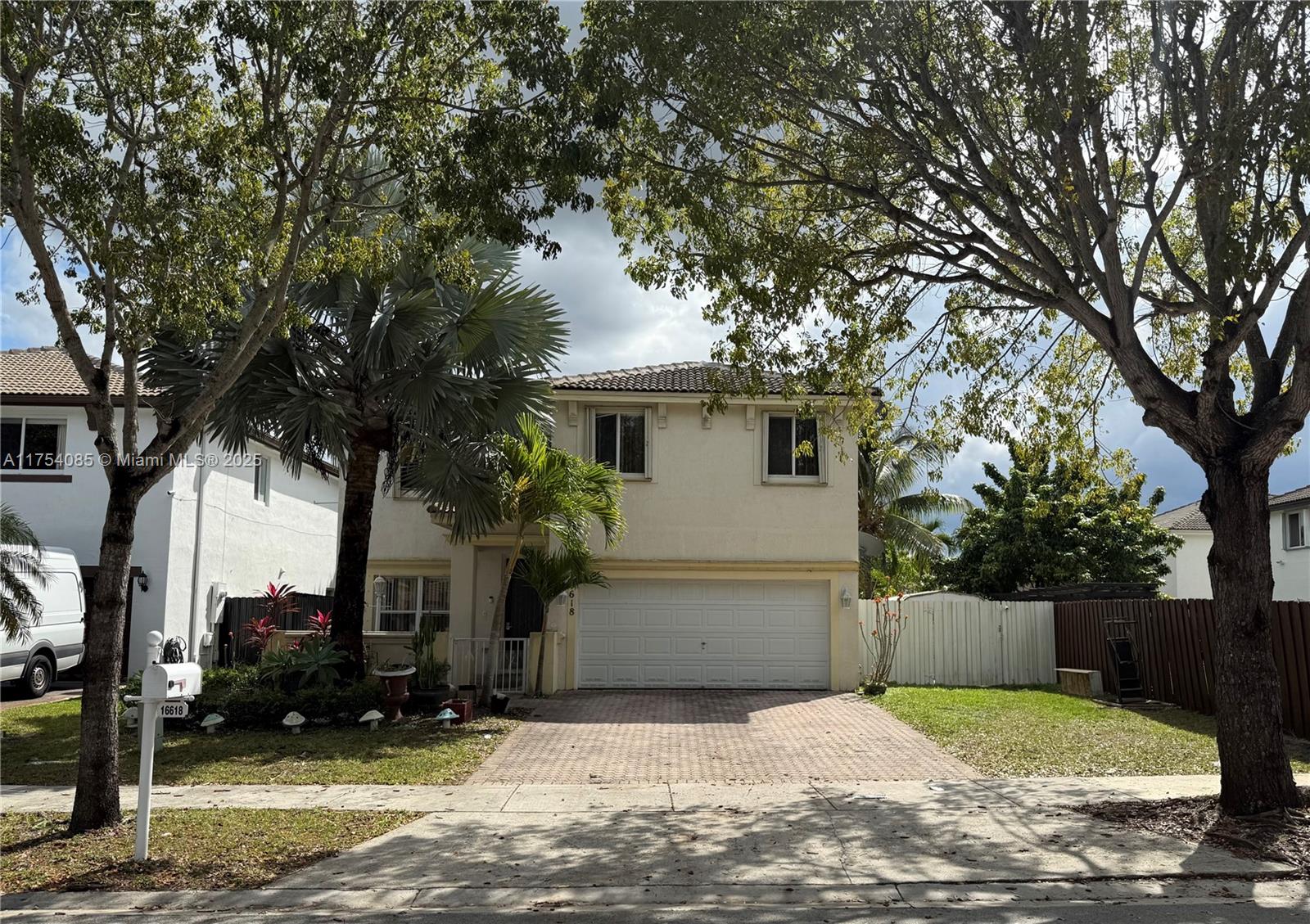 16618 Southwest 68th Terrace Miami, FL 33193 - Photo 2 of 34 a white house that has tree in front of it