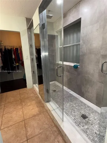 a bathroom with a tub and shower