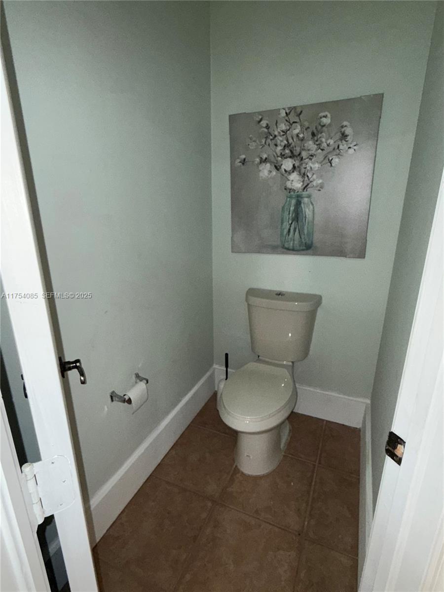 16618 Southwest 68th Terrace Miami, FL 33193 - Photo 22 of 34 a white toilet sitting next to a small bathroom