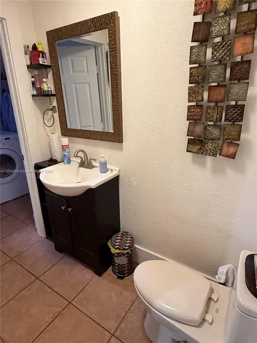 a bathroom with a toilet a sink and mirror