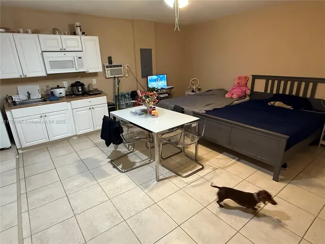 a kitchen with stainless steel appliances a sink a stove a refrigerator and cabinets