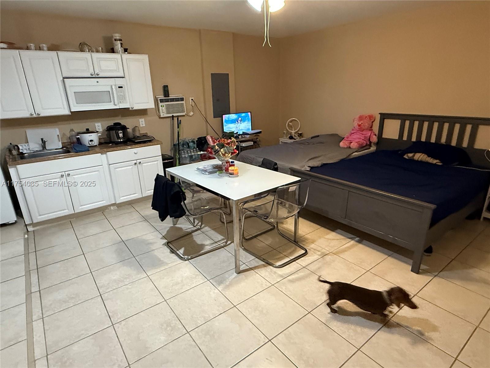 16618 Southwest 68th Terrace Miami, FL 33193 - Photo 32 of 34 a kitchen with stainless steel appliances a sink a stove a table and chairs